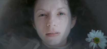 A woman's face partially submerged in water