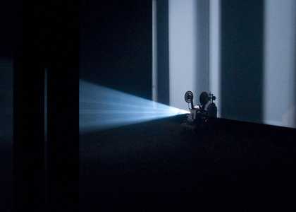 Explanded cinema showing a projector with streaming light