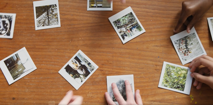 Polaroid photographs on a wooden table